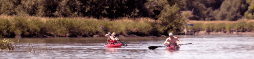 Two men on a kayak in a channel